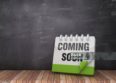 COMMING SOON Calendar on Wood Floor - Chalkboard Background - 3D Rendering