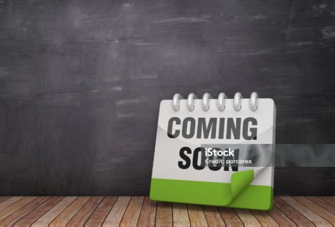COMMING SOON Calendar on Wood Floor - Chalkboard Background - 3D Rendering